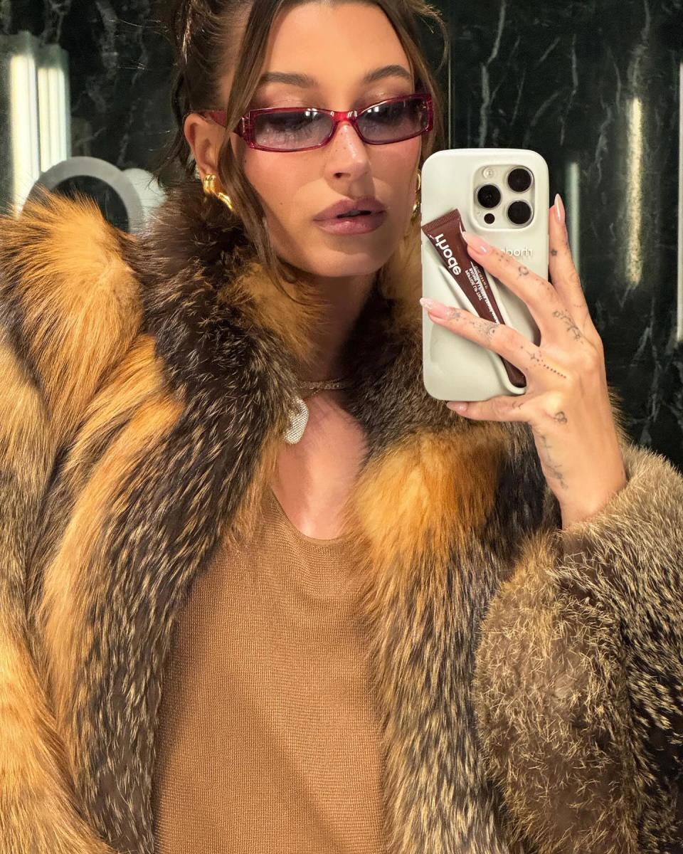 Hailey Bieber Made Us Realize We Need a Phone Case Equipped With a Lip Gloss Holder