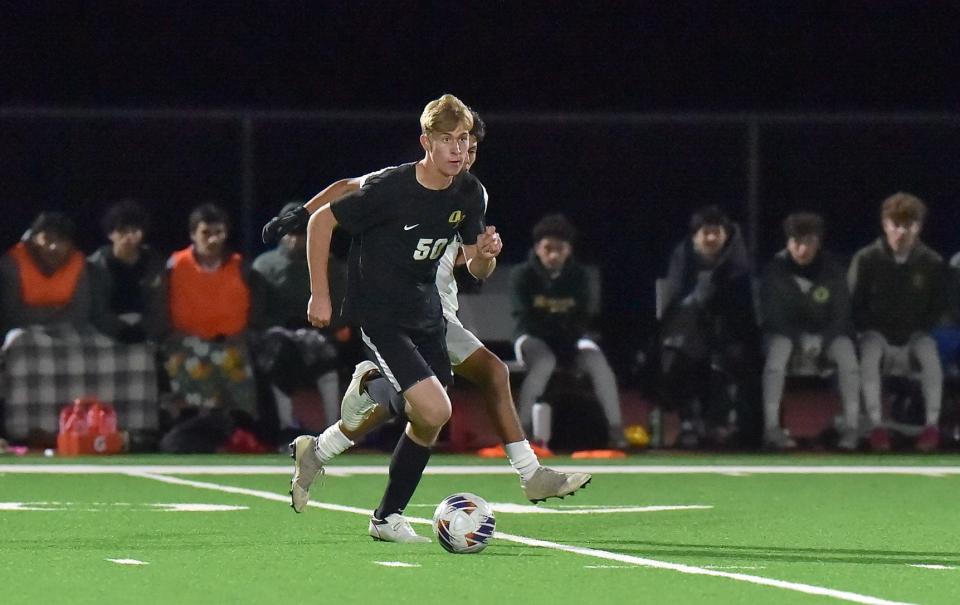 Oak Park's Tyler Cash heads downfield during the Eagles' 2-2 draw with Moorpark in a Coastal Canyon League showdown on Friday, Jan. 12, 2024.