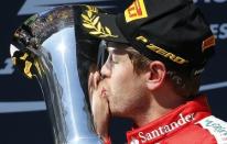 Winner Ferrari Formula One driver Sebastian Vettel of Germany kisses the trophy after the Hungarian F1 Grand Prix at the Hungaroring circuit, near Budapest, Hungary July 26, 2015. REUTERS/Laszlo Balogh