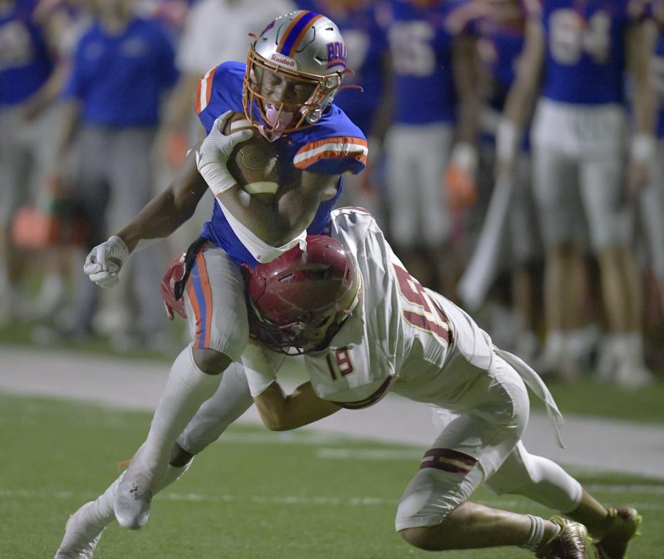 Bolles' Kaleb Lampkins (6) catches a pass as Episcopal's Carson Magyar (19) applies the hit during the second quarter of the Bulldogs' victory.