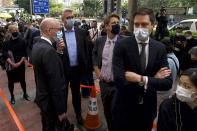 From front left at front, Charles Whiteley, Deputy Head of Office, EU Office, Johannes Harms, Consul of Germany, Joakim Ladeborn, Deputy Consul General of Sweden, Rogier Hekking, Deputy Consul General of Netherlands queue up outside a court to try get in for the hearing in Hong Kong Monday, March 1, 2021. People gathered outside the court Monday to show support for 47 activists who were detained over the weekend under a new national security law that was imposed on the city by Beijing last year. (AP Photo/Vincent Yu)