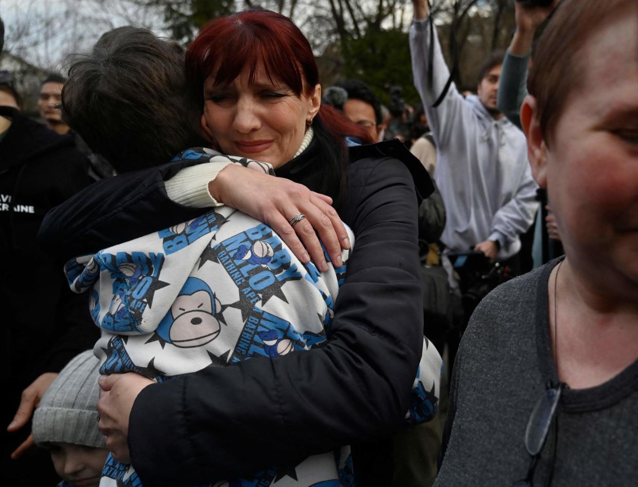 Inessa hugs her son Vitaly after the bus delivering him and more than a dozen other children back from Russian-held territory arrived in Kyiv (AFP/Getty)