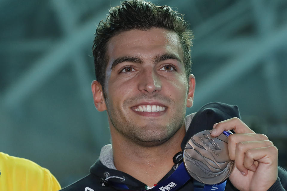 FILE - In this July 21, 2019 file picture, Italy's Gabriele Detti holds his bronze medal after the men's 400m freestyle final at the World Swimming Championships in Gwangju, South Korea. A large portion of the Italian swimming team, 13 elite athletes, including Detti, has been locked in their tiny hotel rooms at a high-altitude training camp in the Alps for nearly two weeks with the coronavirus. (AP Photo/Lee Jin-man, file)