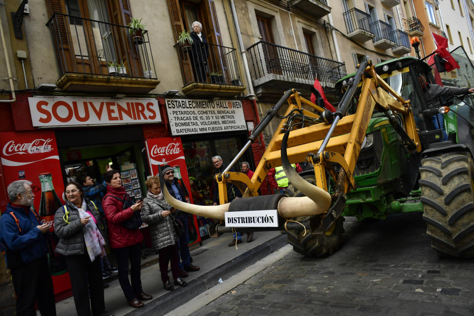 A farmer blocks the center of the city with his tractors during a protest in Pamplona, northern Spain, Wednesday, Feb. 19, 2020. Farmers across Spain are taking part in mass protests over what they say are plummeting incomes for agricultural workers. (AP Photo/Alvaro Barrientos)