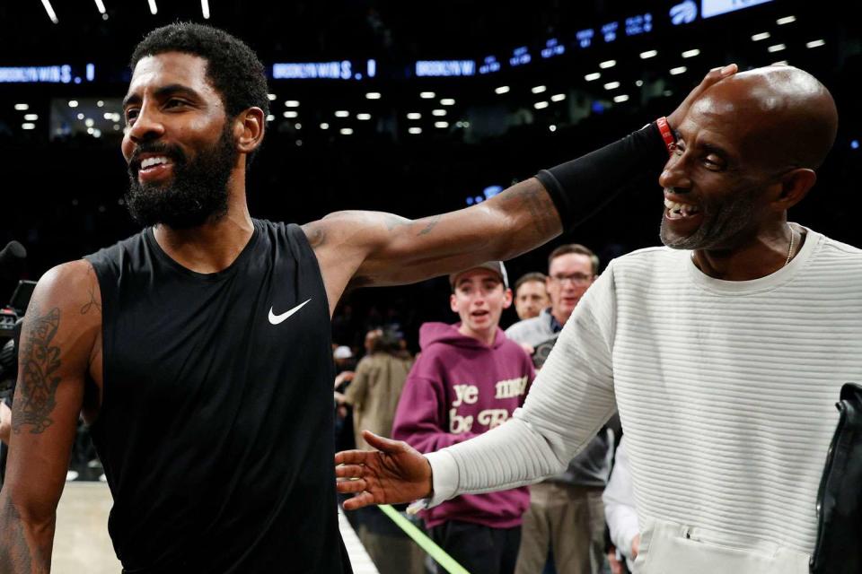 <p>Sarah Stier/Getty</p> Kyrie Irving and his dad, Drederick Irving.