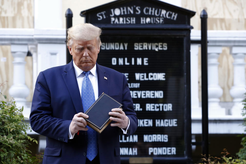 President Donald Trump holds a Bible as he visits outside St. John's Church across Lafayette Park from the White House Monday, June 1, 2020, in Washington. Part of the church was set on fire during protests on Sunday night. (AP Photo/Patrick Semansky)