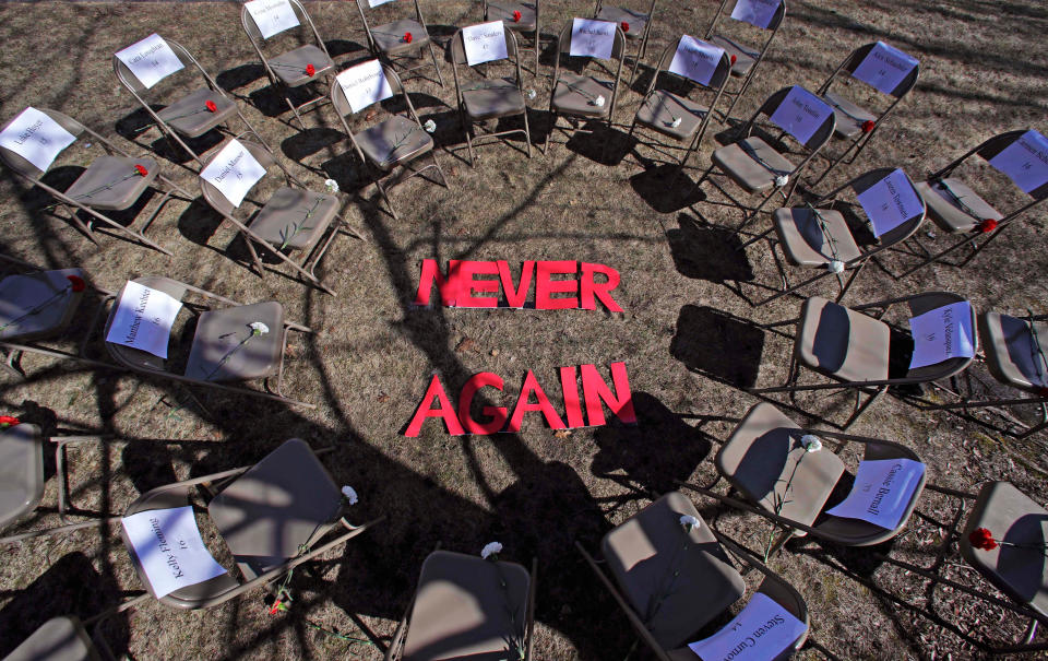 <p>Two rings of chairs encircle the words “NEVER AGAIN” in a silent protest on the 19th anniversary of the Columbine High School shooting outside Trinity High School in Manchester, N.H., Friday, April 20, 2018. The inner ring chairs have names of the Columbine victims, the outer ring chairs have names of the Parkland High School shooting victims. (Photo: Charles Krupa/AP) </p>