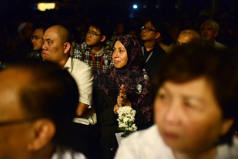 A woman grieves as she watches a video shown during a Karpal Singh memorial held at the Kuala Lumpur-Selangor Chinese Assembly Hall yesterday. – The Malaysian Insider pic by Afif Abd Halim, April 25, 2014.