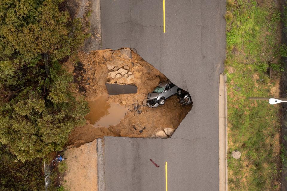 In an aerial view, a car and a pickup truck are seen inside a sinkhole as another storm created by a series of atmospheric rivers inundates California on January 10, 2023 in Los Angeles, California. Two vehicles containing four people fell into the sinkhole which had opened up under the road they were driving on during heavy rainfall in the the suburban Los Angeles neighborhood of Chatsworth. Two people were able to climb out before the hole grew larger, further consuming the vehicles. People from the other vehicle were rescued by about 50 firefighters using a high-angle rope and an aerial ladder to lower a firefighter into the hole and raise a young girl and a woman to the surface. Victims were taken to a hospital with minor injuries. Powerful storms have pounded much of the West Coast since the beginning of the new year, a striking contrast to the past three years of severe to extreme drought experienced by most of the state. The snowpack in the Sierra Nevada Mountains, which supplies water for millions of Californians, is now above average to date. Last winter, a fraction of average snowfall in the Sierras left the high mountain range virtually devoid of the usual summer snow patches. Though damaging yet not enough to make up for years of drought, the heavy precipitation brings a level of relief from an anticipated fourth year of drought in 2023.