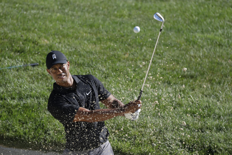 Tiger Woods hits out of a bunker on the 15th hole during a practice round ahead of the Memorial Tournament on Tuesday, July 14, 2020, in Dublin, Ohio.