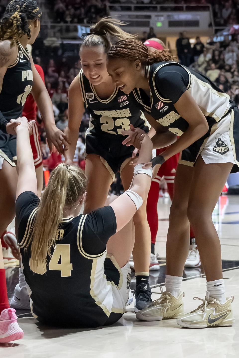 Teammates help Purdue Boilermakers forward Caitlyn Harper (34) up after a hard foul during the NCAA women’s basketball game against the Indiana Hoosiers, Sunday Jan. 21, 2024, at Mackey Arena in West Lafayette, Ind. Indiana won 74-68.