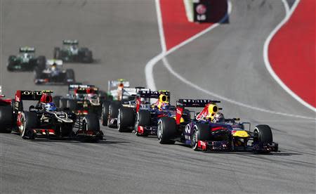 Red Bull Formula One driver Sebastian Vettel (R) of Germany leads the pack in front of teammate Mark Webber (2nd R) of Australia and Lotus Formula One driver Romain Grosjean of France during the Austin F1 Grand Prix at the Circuit of the Americas in Austin November 17, 2013. REUTERS/Adrees Latif