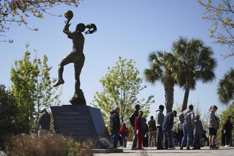 South Carolina basketball fans wait outside Colonial Life Arena near a statue of A'ja Wilson before a women's second-round college basketball game against South Florida in the NCAA Tournament, Sunday, March 19, 2023, at Colonial Life Arena in Columbia, S.C. Despite all the positive numbers, the women's tournament loses money — in large part because of the lack of television revenue. (AP Photo/Sean Rayford)