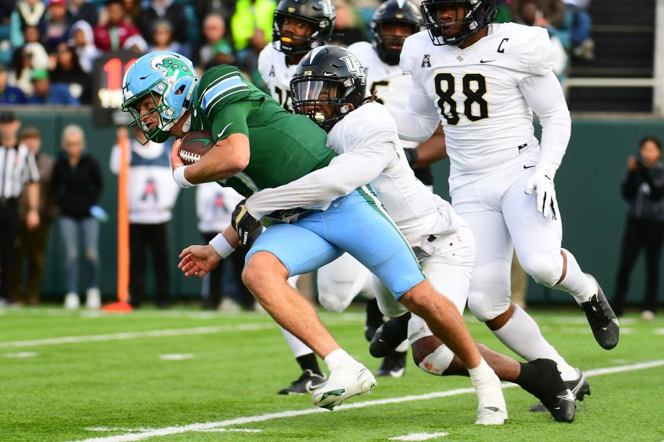 Central Florida linebacker Walter Yates III (27) sacks Tulane quarterback Michael Pratt (7) during the second quarter of their game at Yulman Stadium.