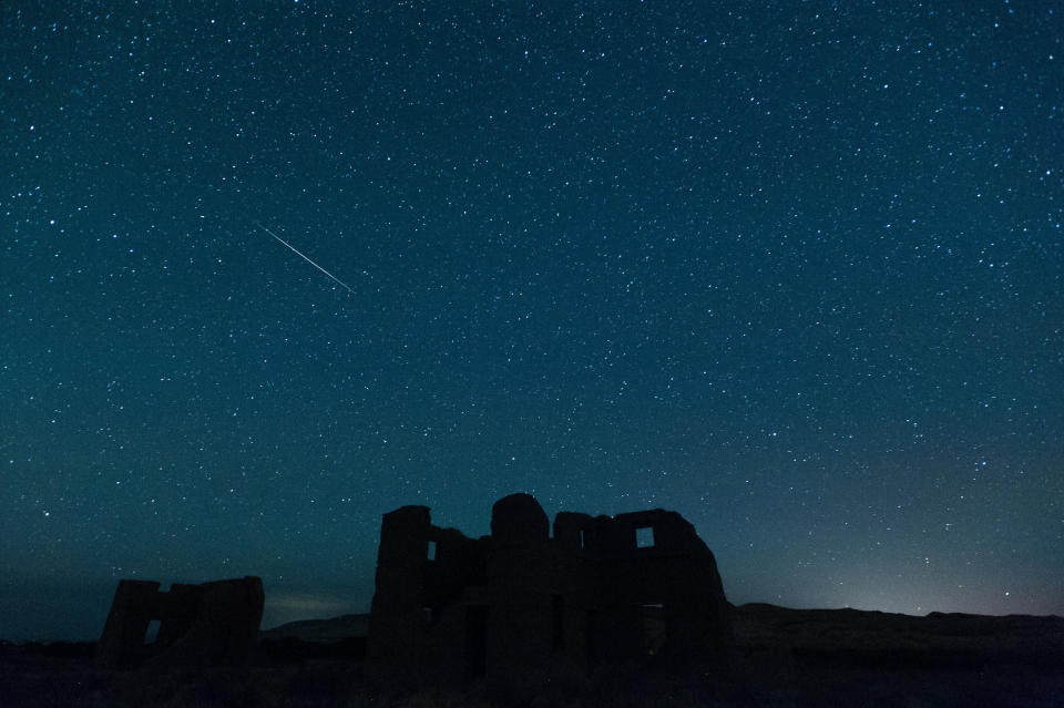 In this photo provided by Kevin Clifford, a meteor from the annual Perseid meteor shower falls from space over ruins at Fort Churchill State Historic Park on Sunday, Aug. 12, 2012, in Silver Springs, Nev. The Perseid meteors are debris left from the comet Swift-Tuttle. Fort Churchill was built in 1861 by the United States army to protect early settlers. (AP Photo/Kevin Clifford)