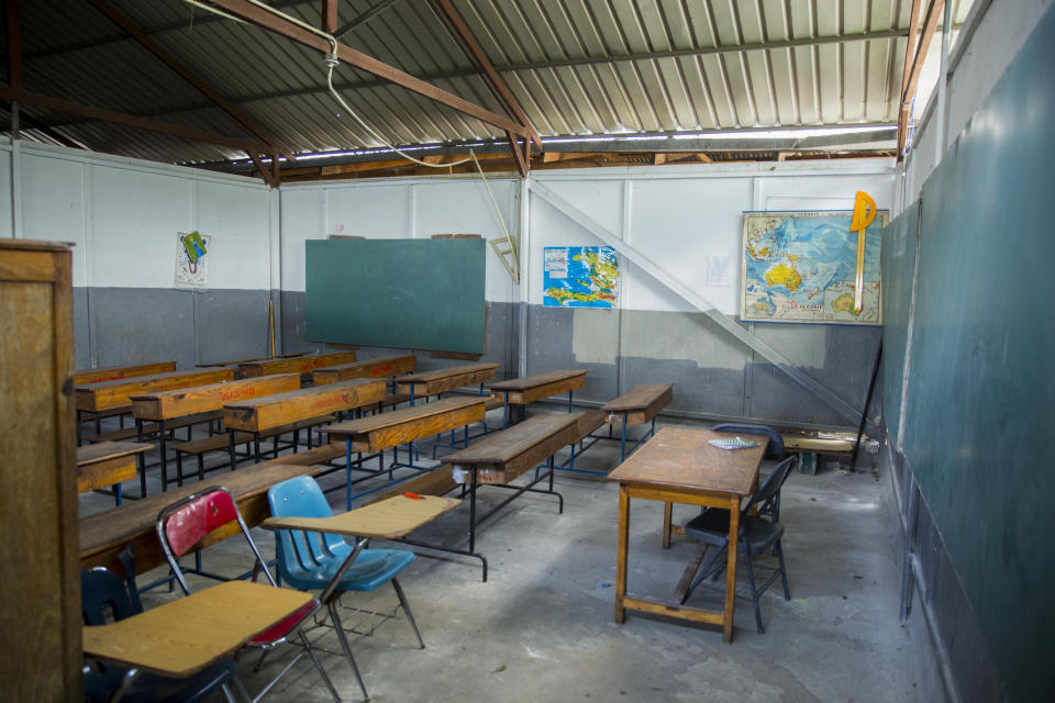 A empty classroom sits empty of students at a Catholic school in the Croix-des-Bouquets neighborhood of Port-au-Prince, Haiti, Wednesday, April 21, 2021. Catholic institutions including schools and universities closed Wednesday across Haiti as part of a three-day protest to demand the release of nine people including five priests and two nuns kidnapped more than a week ago amid a spike in violence the government is struggling to control. (Photo Joseph Odelyn)