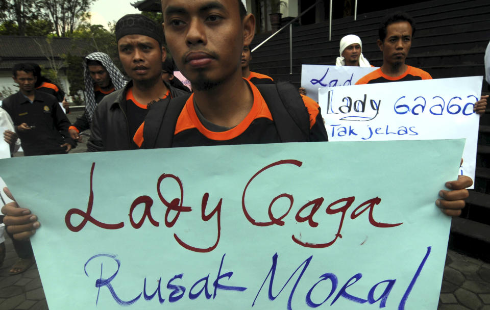 Muslim youths hold posters during a protest against Lady Gaga's concert that is scheduled to be held on June 3, in Solo, Central Java, Indonesia, Wednesday, May 23, 2012. Lady Gaga might have to cancel her sold-out show in Indonesia because police worry her sexy clothes and dance moves undermine Islamic values and will corrupt the country's youth. The writing on the poster says "Lady Gaga corrupts moral." (AP Photo)