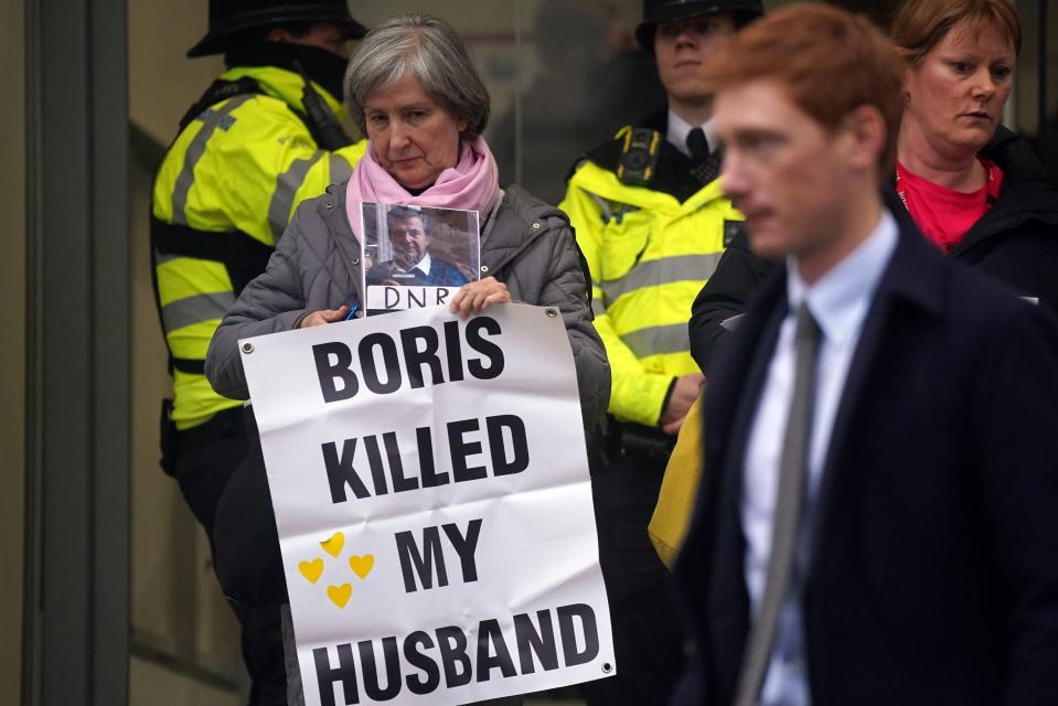 Protesters wait outside the UK Covid-19 Inquiry at Dorland House in London (PA)