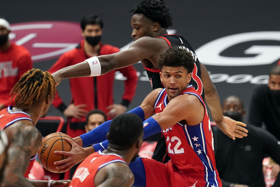 Philadelphia 76ers guard Matisse Thybulle (22) grabs a rebound away from Toronto Raptors forward OG Anunoby (3) during the first half of an NBA basketball game Tuesday, Feb. 23, 2021, in Tampa, Fla. (AP Photo/Chris O'Meara)