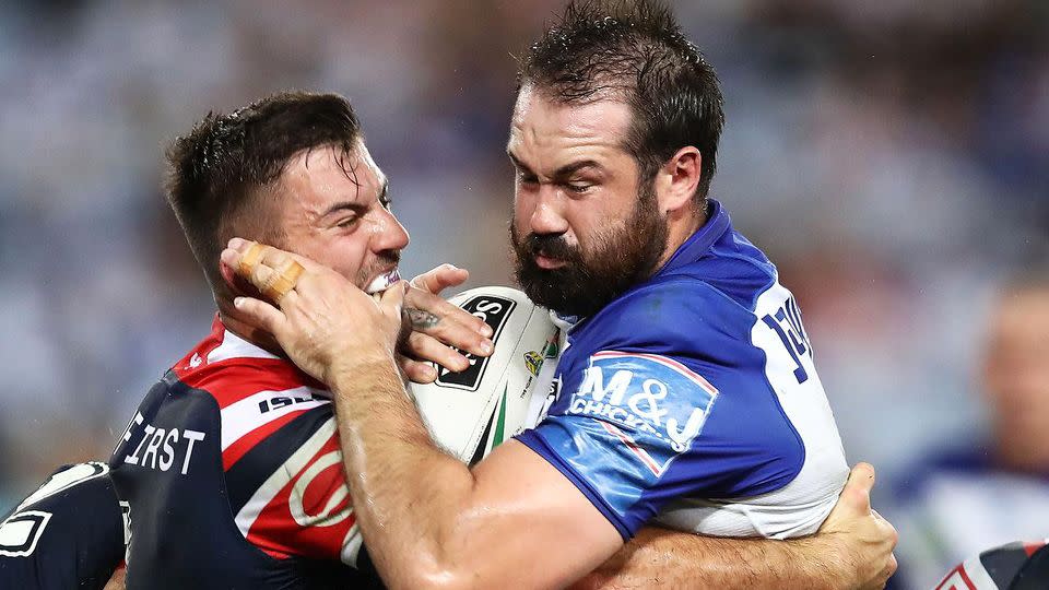 Woods barges forward against the Roosters. Pic: Getty