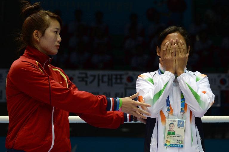 Sarita Devi (R) after she refused to accept her bronze medal for the women's lightweight (57-60kg) boxing at the 2014 Asian Games, October 1, 2014