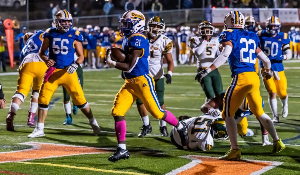 Catholic Memorial's Xavier McClinton (21) strolls into the end zone for a touchdown during a WIAA Division 4 playoff game on Oct. 20. Catholic Memorial football is among the programs impacted by the newly-instituted WIAA tournament performance factor. The Crusaders will move from Division 4 to 3 next season.