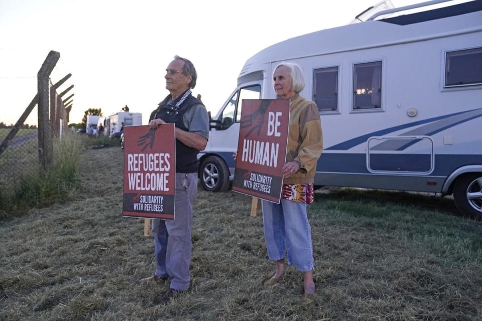 Protesters at the perimeter of MoD Boscombe Down, near Salisbury, where a Boeing 767 aircraft was believed to be the plane set to take asylum seekers from the UK to Rwanda (Andrew Matthews/PA) (PA Wire)