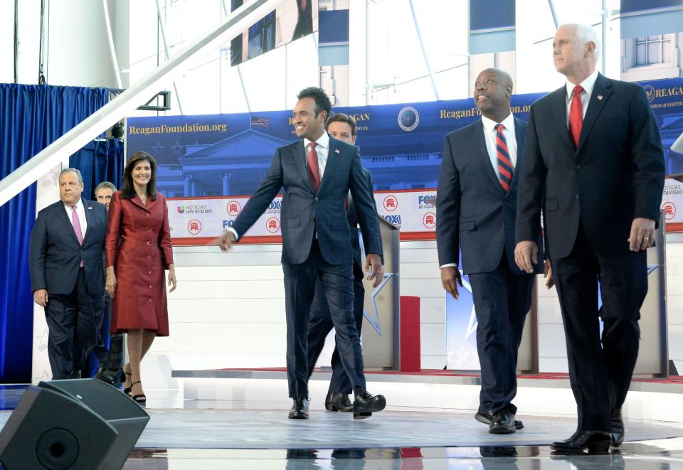 Walking from from left, North Dakota Gov. Doug Burgum, former New Jersey Gov. Chris Christie, former South Carolina Gov. Nikki Haley, Florida Gov. Ron DeSantis, businessman Vivek Ramaswamy, South Carolina Sen. Tim Scott, and former Vice President Mike Pence, come out to the stage at the Ronald Reagan Presidential Library & Museum in Simi Valley on Wednesday.