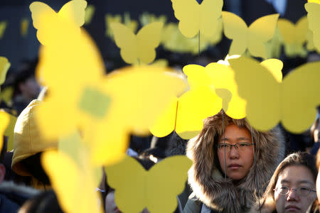 People hold up yellow colored butterflies dedicated to a former South Korean "comfort woman" Kim Bok-dong during her funeral in Seoul, South Korea, February 1, 2019. REUTERS/Kim Hong-Ji