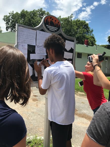 Josh Hagene, another Cultural Leadership teen, adds Till&rsquo;s history back to his marker. (Photo: Cultural Leadership)