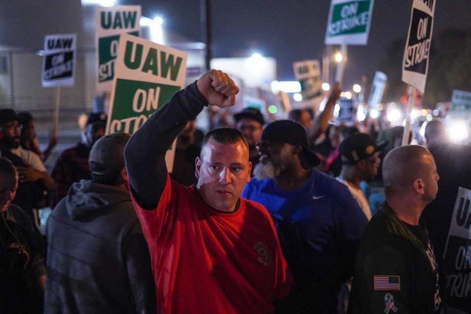 Tommy Wolikow throws his fist in the air in solidarity while standing with other UAW members as workers leave Flint Assembly early Sept. 16, 2019 while taking part in a national strike against General Motors after stalled contract negotiations with General Motors. The workers are on the first national UAW strike since 2007.