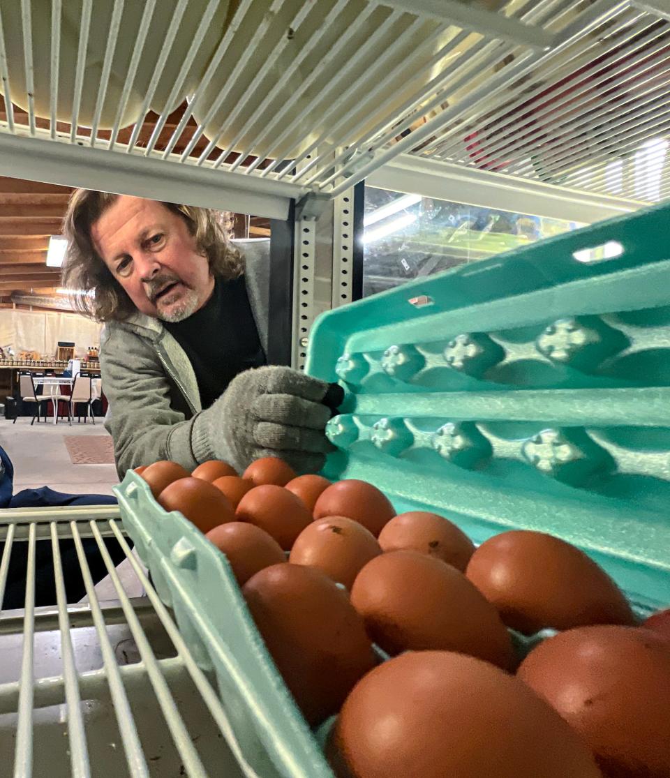 Jay Yates looks at an 18-egg carton of free range eggs sold at Whitehall Produce, eggs from Sugar Maple Farm in Starr, S.C. in Anderson, S.C. Saturday, January 21, 2023. Yates said the eggs sell well, as the local farm eggs are an alternative source than ones from further away. 