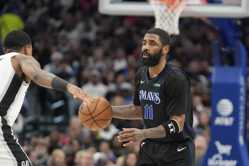 Dallas Mavericks guard Kyrie Irving (11) dribbles against San Antonio Spurs guard Blake Wesley during the second half of an NBA basketball game in Dallas, Wednesday, Feb. 14, 2024. (AP Photo/LM Otero)