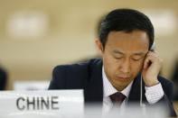 Chinese diplomat Zhang Yaojun listens during a session of the Human Rights Council at the United Nations European headquarters in Geneva March 25, 2015. REUTERS/Denis Balibouse