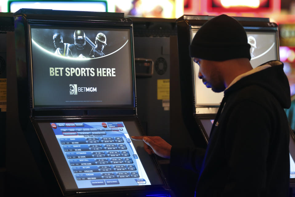 A patron enters his bet during the launch of legalized sports betting in Michigan at the MGM Grand Detroit casino in Detroit earlier this year. (AP Photo/Paul Sancya)