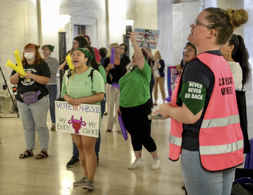 Abortion rights supporters demonstrate outside the Senate chamber at the West Virginia state Capitol on Tuesday, Sept. 13, 2022, in Charleston, W.Va., as lawmakers debated a sweeping bill to ban abortion in the state with few exceptions. (Chris Dorst/Charleston Gazette-Mail via AP)