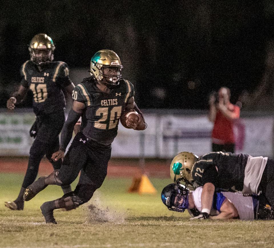 Trinity Catholic Celtic's Beau Beard (20) carries the ball for a first down in the first quarter against John Carroll at Trinity Catholic in Ocala, FL on Friday, December 2, 2022. [Cyndi Chambers/Ocala Star Banner] 2022