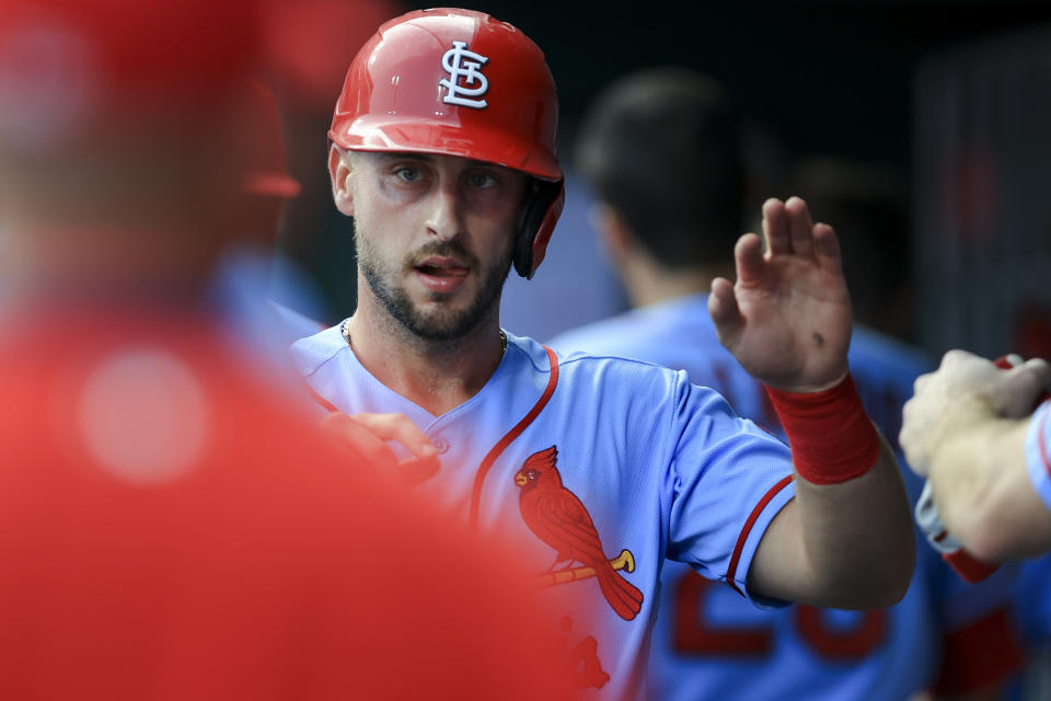 St. Louis Cardinals' Paul DeJong high-fives teammates after scoring during the second inning of the team's baseball game against the Cincinnati Reds in Cincinnati, Saturday, July 24, 2021. (AP Photo/Aaron Doster)
