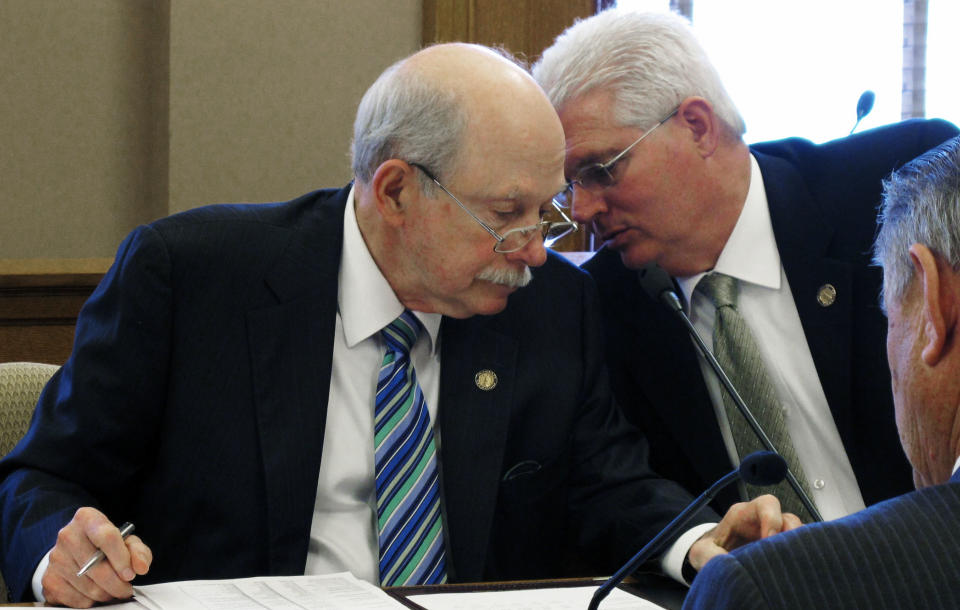 Kansas state Sens. Les Donovan, left, a Wichita Republican, and Pat Apple, right, a Louisburg Repubilcan, confer during negotiations with House members over tax cuts, Thursday, April 26, 2012, at the Statehouse, in Topeka, Kan. (AP Photo/John Hanna)