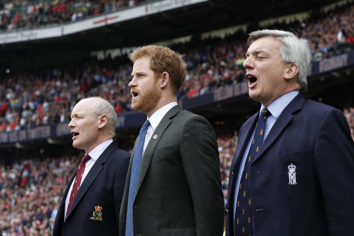 Prince Harry (centre) sings the national anthem at Twickenham stadium ahead of the Army V Royal Navy annual rugby match: PA