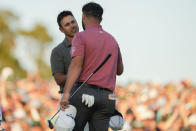 Brooks Koepka, left, congratulates Jon Rahm, of Spain, on Rahm's winning the Masters golf tournament at Augusta National Golf Club on Sunday, April 9, 2023, in Augusta, Ga. (AP Photo/Charlie Riedel)