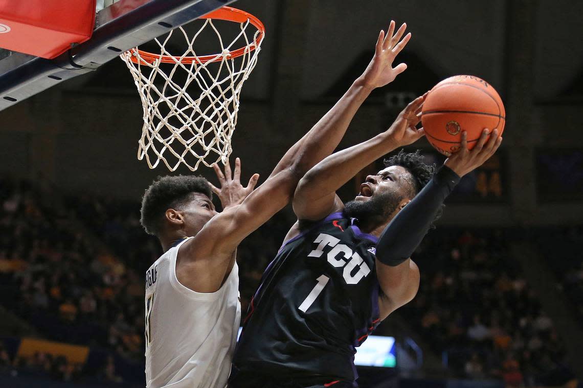 TCU guard Mike Miles Jr. (1) is defended by West Virginia forward Mohamed Wague during the first half of an NCAA college basketball game Wednesday, Jan. 18, 2023, in Morgantown, W.Va.