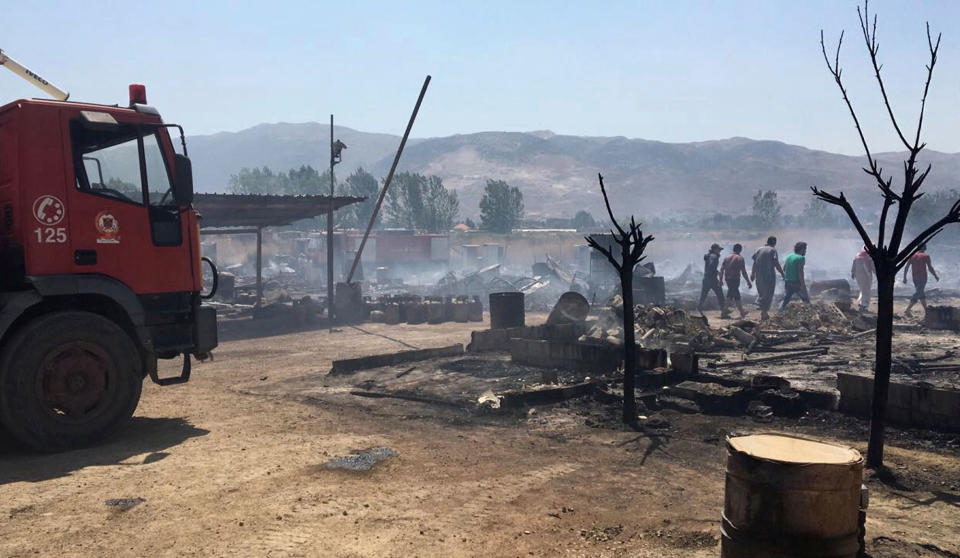 <p>This photo provided by the Qab Elias Emergency Services, shows Lebanese Civil Defense workers putting out a fire in a Syrian refugee camp in Qab Elias, a village in the Bekaa Valley, Lebanon in Qab Elias, Lebanon, Sunday, July 2, 2017. Lebanon’s state news agency and the Red Cross say a major fire has broken out in a Syrian refugee settlement, killing at least one person and sending large plumes of black smoke into the sky. (Qab Elias Emergency Services via AP) </p>