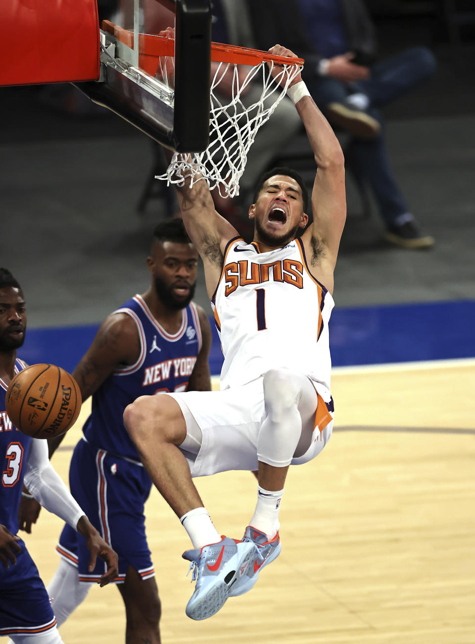 Phoenix Suns' Devin Booker (1) celebrates after his dunk against the New York Knicks in the third quarter of an NBA basketball game Monday, April 26, 2021, in New York. (Elsa/Pool Photo via AP)