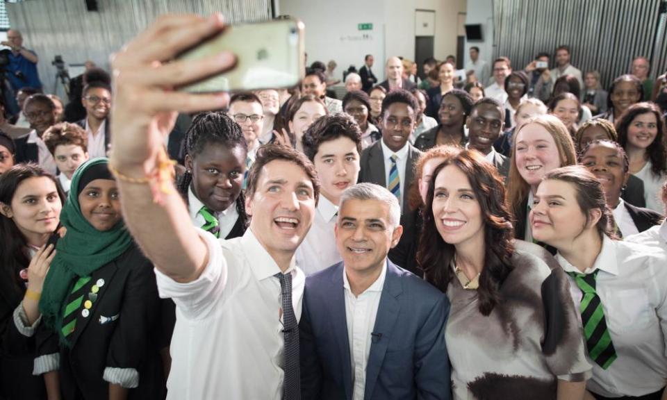 Canadian PM Justin Trudeau (left) takes a selfie with London mayor Sadiq Khan and New Zealand PM Jacinda Ardern at City Hall in London