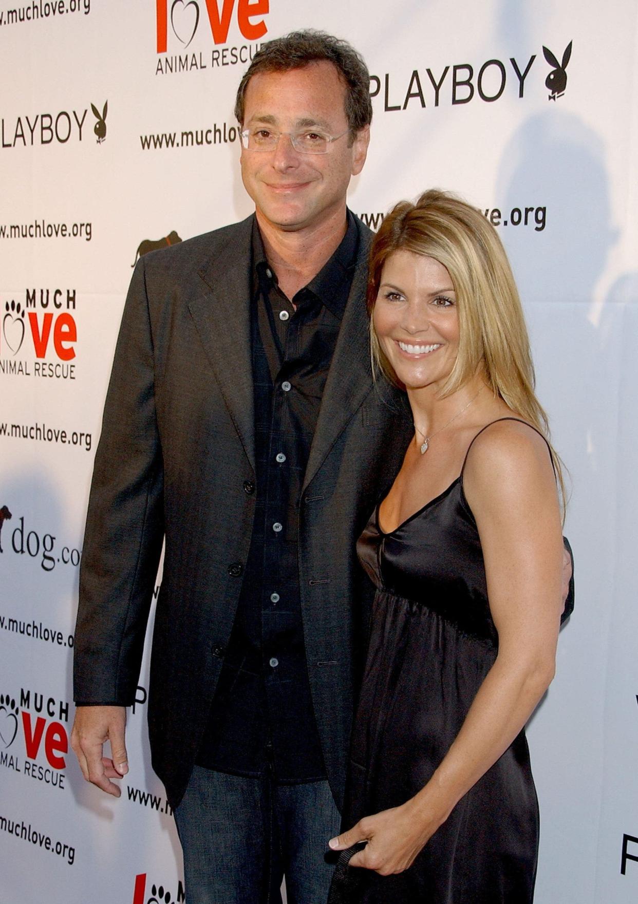 Bob Saget and Lori Loughlin posing together on the red carpet