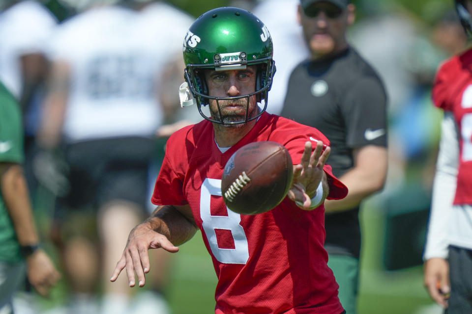 New York Jets quarterback Aaron Rodgers participates in a drill at the NFL football team's training facility in Florham Park, N.J., Sunday, July 23, 2023. (AP Photo/Seth Wenig)