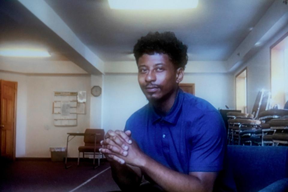 Tyus Reed, shown at his workplace, Williams and Associates in Tacoma, Washington, credits his decision to become a peer support coordinator at Wraparound with Intensive Services to his mentor, Evelyn Clark, whom he met while he was incarcerated for a gang-related drive-by shooting when he was 17. (Portrait taken remotely by Michele Abercrombie / News21)