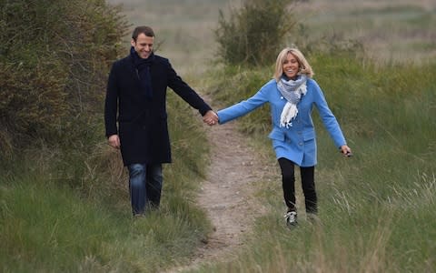 Emmanuel Macron and wife Brigitte stroll in Le Touquet, northern France - Credit: ERIC FEFERBERG/AFP