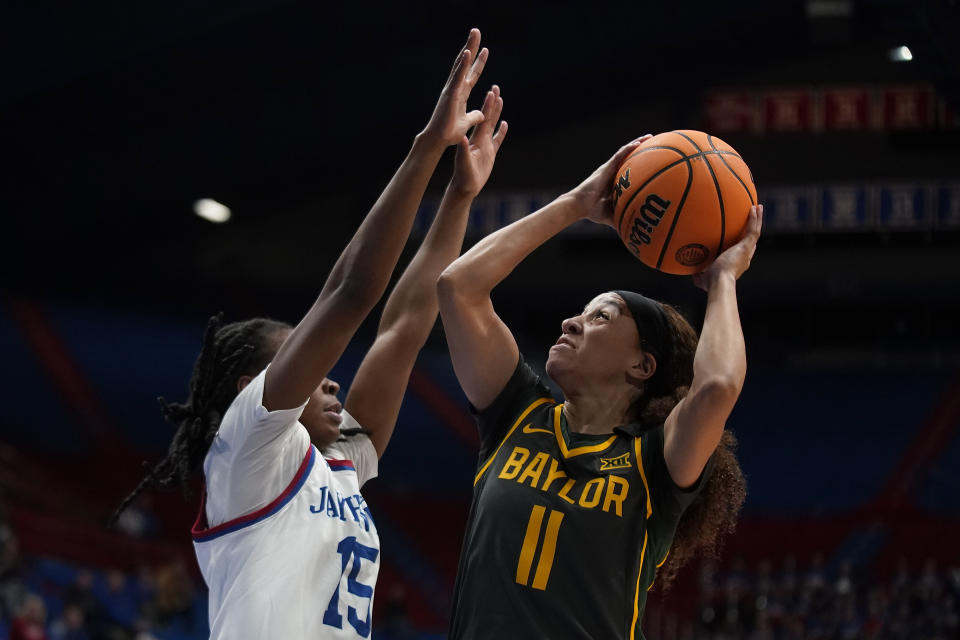 Baylor guard Jada Walker (11) shoots over Kansas guard Zakiyah Franklin (15) during the first half of an NCAA college basketball game Wednesday, Jan. 10, 2024, in Lawrence, Kan. (AP Photo/Charlie Riedel)